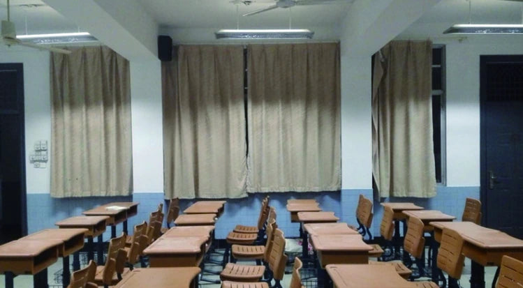 Classroom in Wenzhou with suspended lighting above wooden desks