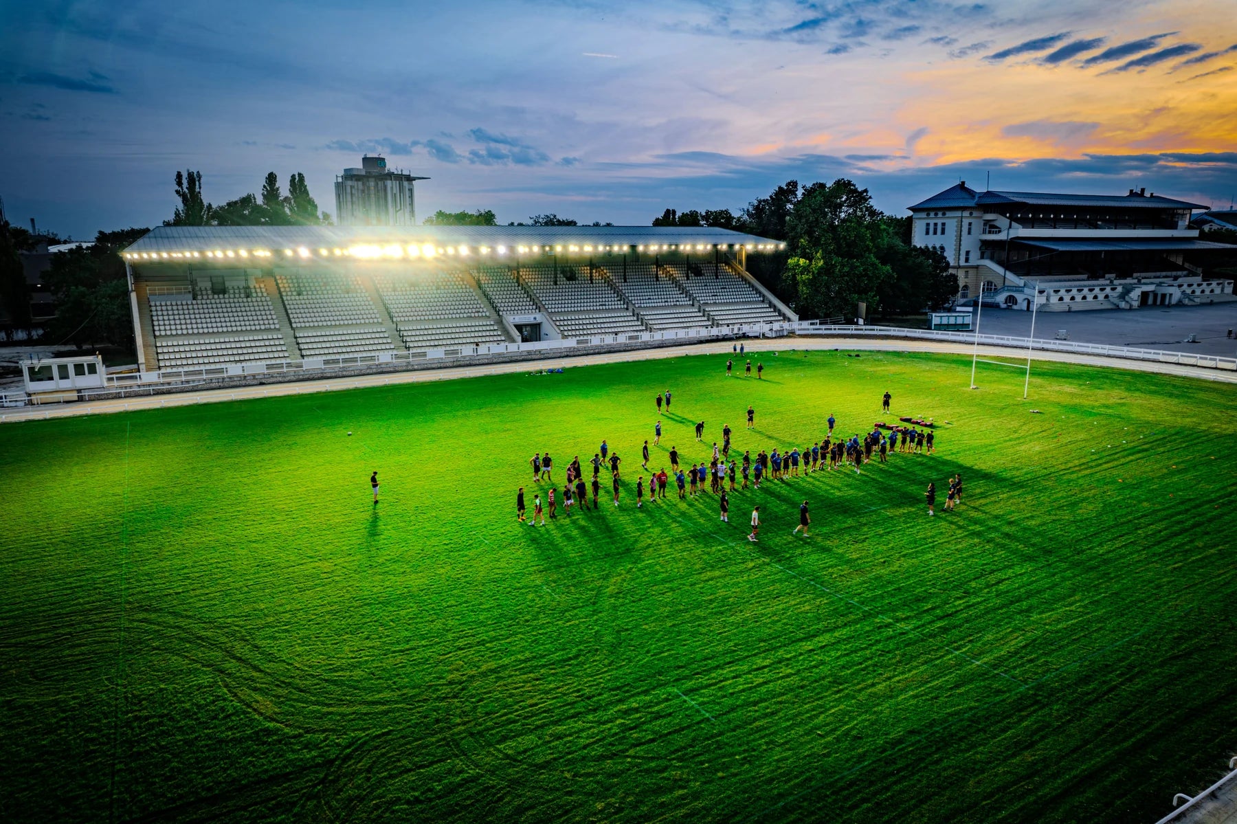 A sports field illuminated for evening practice